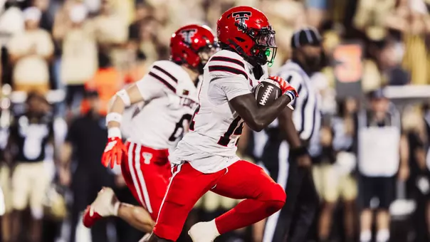 Brice Pollock returns an interception with John Curry running in the background during the second half of Texas Tech's win at Colorado.