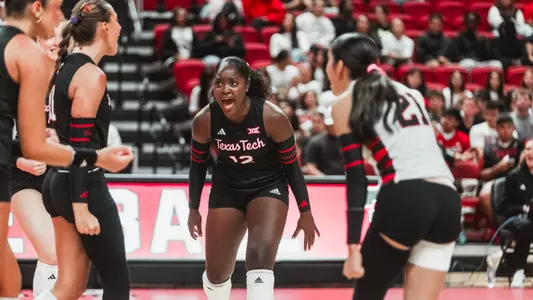 Taylor Cook celebrating a point with her teammates in a volleyball
