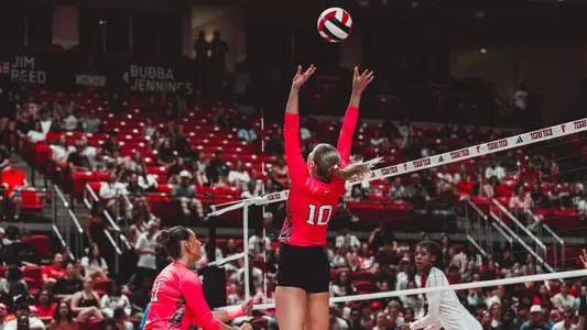 Katleyn Cochran setting a ball for teammate in a Texas Tech volleyball match