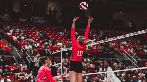 Katleyn Cochran setting a ball for teammate in a Texas Tech volleyball match