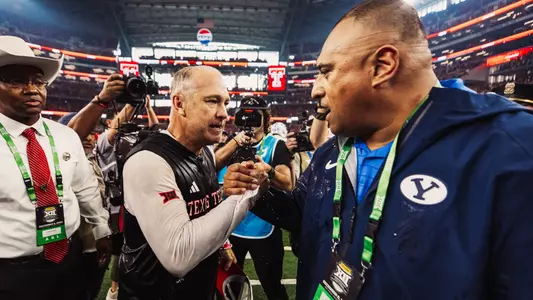 Texas Tech head coach Joey McGuire shakes hands at midfield with BYU's Kilane Sitake after winning the school's first Big 12 Championship.