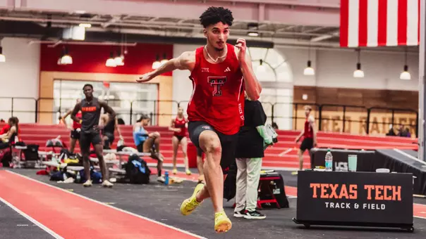 Zaid Latif sprinting down the runway before he long jumps into the sand pit
