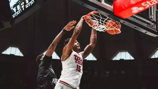 JT Toppin throws down a two-handed dunk over a Colorado defender.