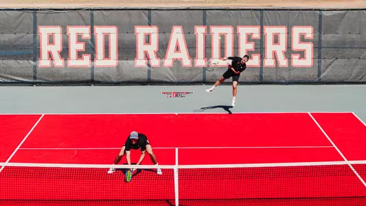 Sebastian Abboud serving during a doubles match. Texas Tech Men's Tennis vs UNM on February 15, 2026 (Photo by Adele Clarke/Texas Tech Athletics)
