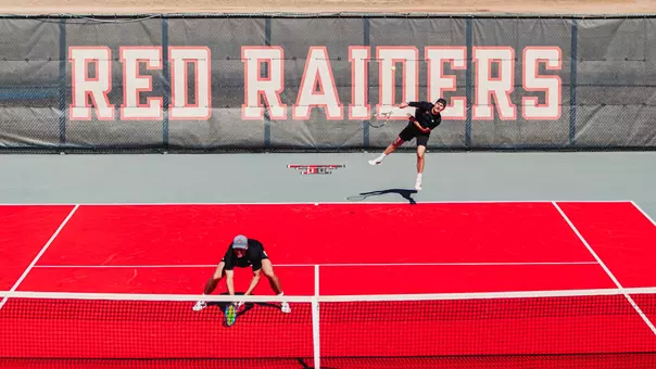 Sebastian Abboud serving during a doubles match. Texas Tech Men's Tennis vs UNM on February 15, 2026 (Photo by Adele Clarke/Texas Tech Athletics)