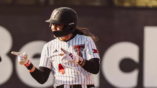 Lagi Quiroga at 2nd base celebrating a double she hit in the texas tech softball game against nebraska in the clearwater invitational