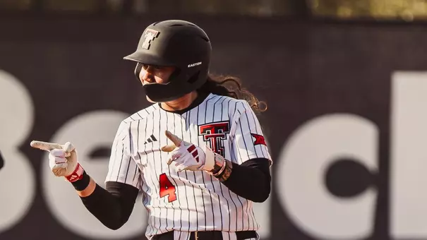Lagi Quiroga at 2nd base celebrating a double she hit in the texas tech softball game against nebraska in the clearwater invitational
