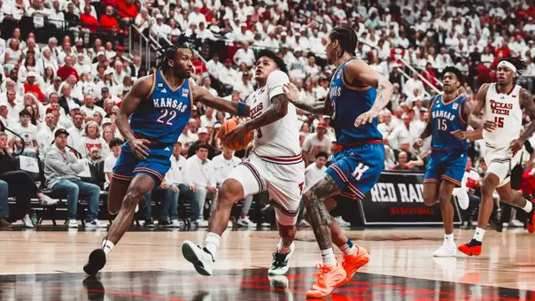 LeJuan Watts drives to the basket through two Kansas defenders.