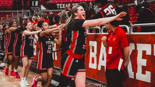 The Lady Raiders high-five fans after beating Baylor.