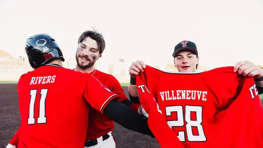 Texas Tech 1B Robin Villeneuve hugs teammate Davis Rivers while Matt Quintanar holds up Villeneuve's Red No. 28 Texas Tech uniform following the infielders towering walk-off two-run home run that propelled Texas Tech to an 8-6 win and a doubleheader sweep over UAlbany, Saturday afternoon at Rip Griffin Park at Dan Law Field.