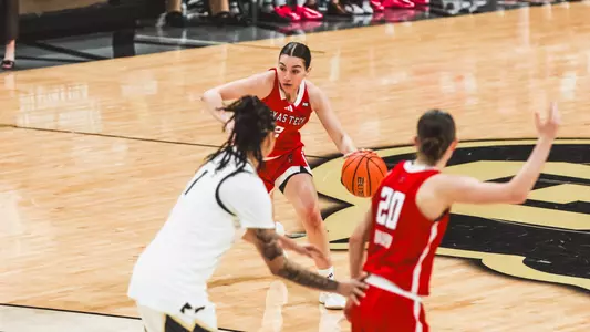 Gemma Nunez dribbling the ball down the court.