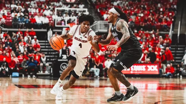 Christian Anderson drives past a Kansas State defender to score two of his 21 points in the win.