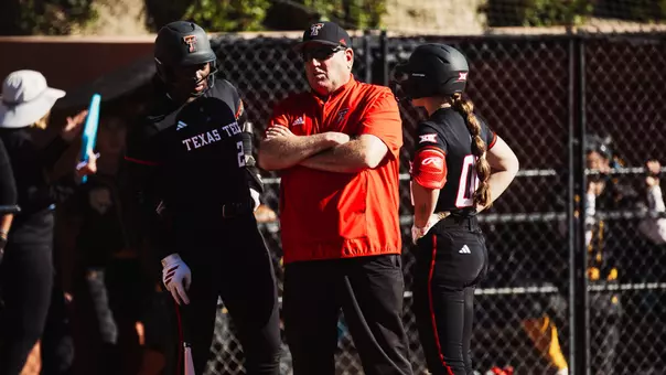 Gerry Glasco speaking to NiJaree Canady and Jackie Lis before they bat