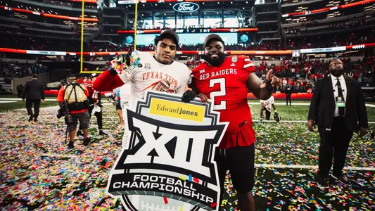 Romello Height and Lee Hunter celebrate with the Big 12 Championship sign after Texas Tech's win over BYU in AT&T Stadium.