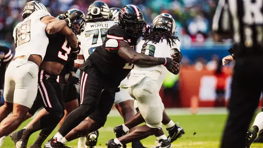 Lee Hunter breaks through the middle to wrap up an Oregon rusher behind the line of scrimmage in the Capital One Orange Bowl.