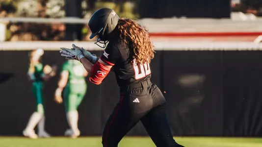 Jackie Lis claps while rounding first base after hitting her second home run of the game against North Texas