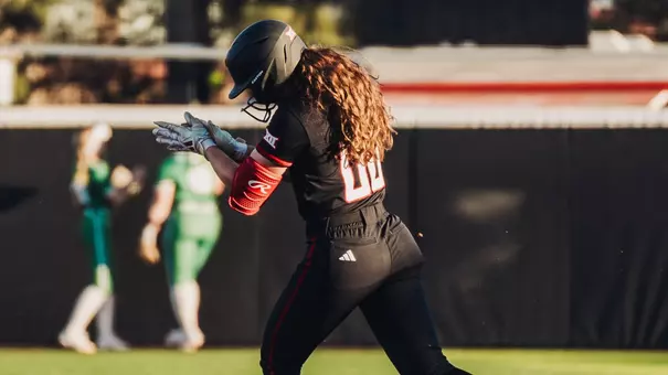 Jackie Lis claps while rounding first base after hitting her second home run of the game against North Texas