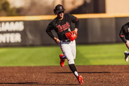 Texas Tech Freshman Linkin Garcia wearing the 'Black Gladiator' uniform fields a ball at shortstop during the 2026 Alumni Game.