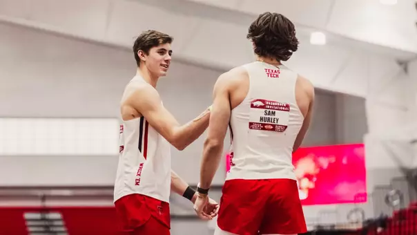 Jackson Bragg dapping up his teammate Sam Hurley at the Razorback Invitational