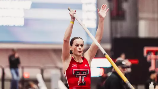 Kashlee Dickinson raises her hands in the air before a pole vault attempt