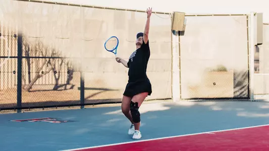 Andreea Lila throwing the ball up to serve. Texas Tech vs Sam Houston State Women's Tennis on February 1st, 2026 in Lubbock, TX. (Photo by Rane Paulson/Texas Tech Athletics)