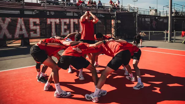 The Texas Tech men's tennis team hypes each other up on the court before playing against UTRGV.