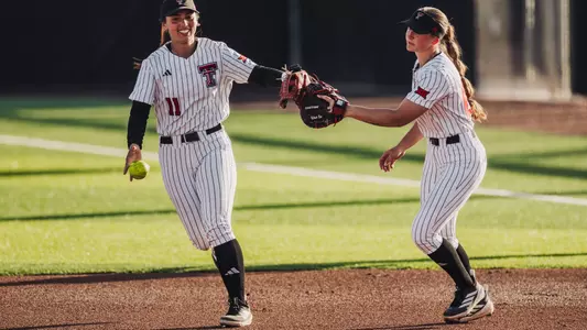 Lauren Allred and Jackie Lis celebrate an inning-ending out for Texas Tech softball