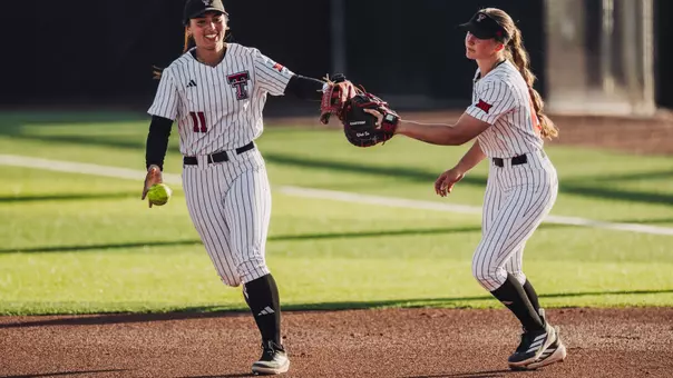 Lauren Allred and Jackie Lis celebrate an inning-ending out for Texas Tech softball