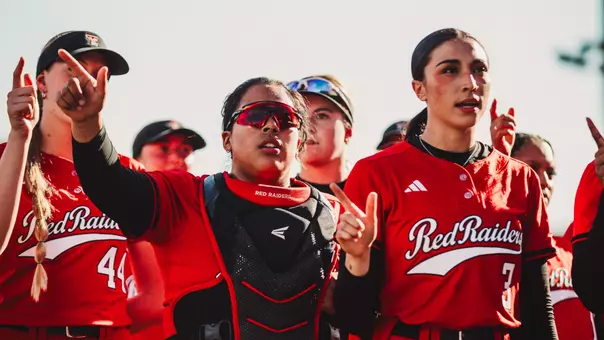 Victoria Valdez and Makayla garcia giving the guns up as they sing the matador song after a Texas Tech win