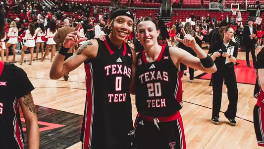 Snudda Collins and Bailey Maupin posing for the camera after a senior day winl.
