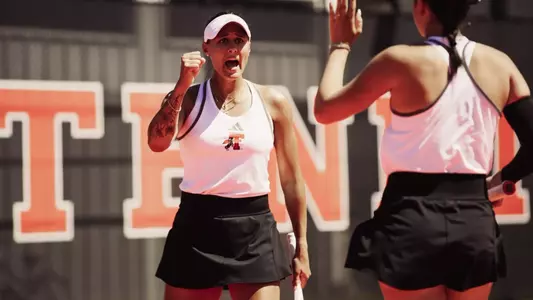 Yekaterina Dmitrichenko celebrating after winning a doubles point.