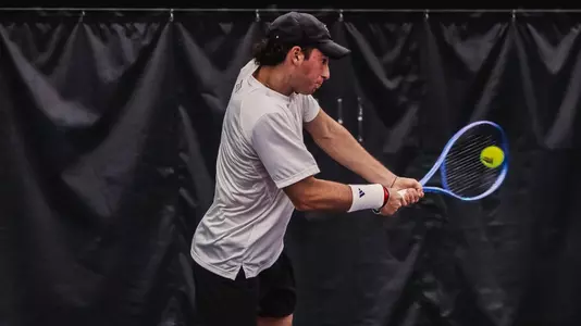 Thiago Guglieri hitting a backhand at TCU.