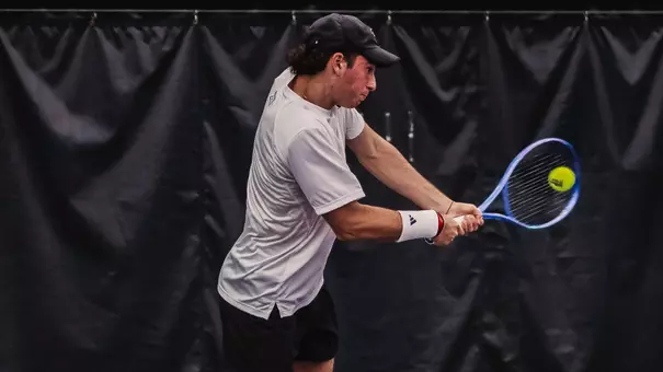 Thiago Guglieri hitting a backhand at TCU.