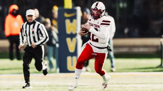 Mitch Griffis runs in the open field after entering the game in the second half of Texas Tech's road win at West Virginia to close the regular season.