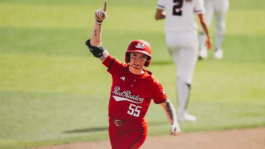 Kaitlyn terry celebrating a home run she hit in a softball game