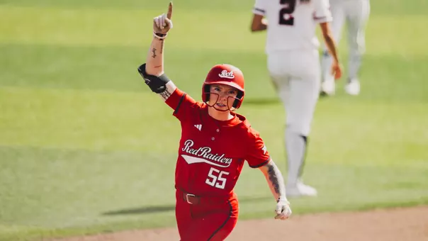 Kaitlyn terry celebrating a home run she hit in a softball game