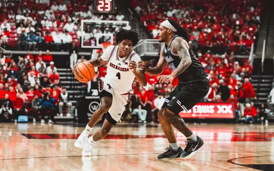Christian Anderson drives to the basket against a K-State defender.