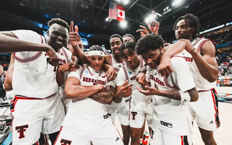 The Red Raiders celebrate a win over Akron on the court together after advancing in the NCAA Tournament.