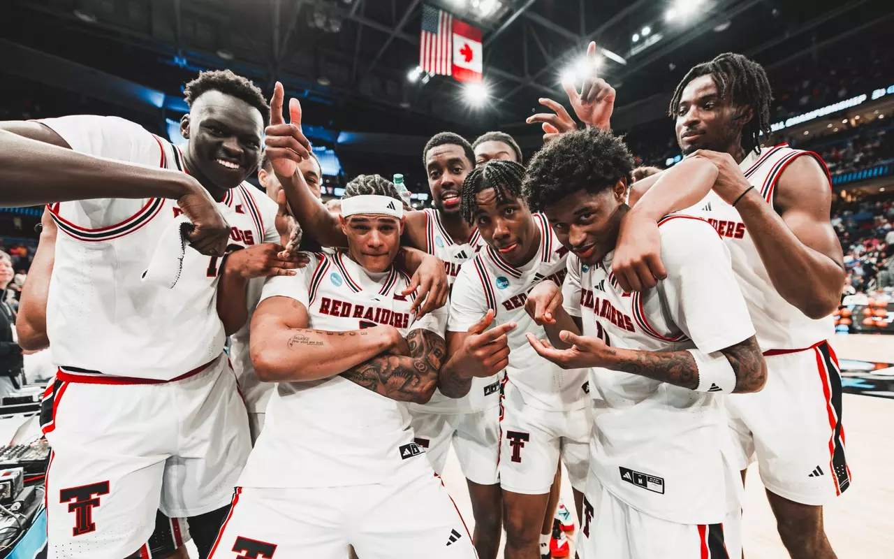 The Red Raiders celebrate a win over Akron on the court together after advancing in the NCAA Tournament.