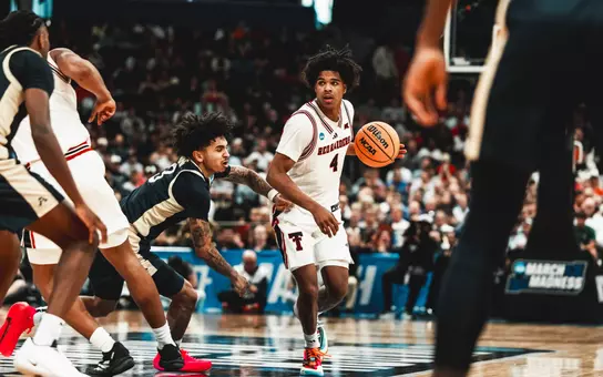 Christian Anderson looks for room to work against the Akron defense in the NCAA Tournament.