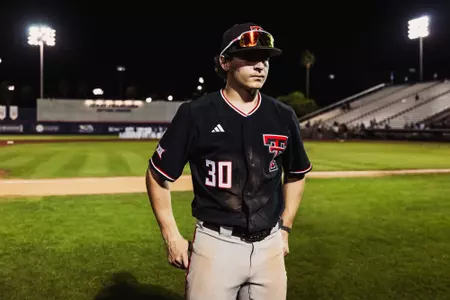 Texas Tech OF/LHP Jesse Rusinek stands on the field post game in his dust covered uniform after Tech's dramatic 9-5 come-from-behind win Friday night at Arizona.