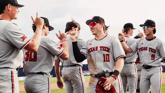 Logan Hughes (10) and the Red Raiders shake hands in celebration following the 12-10 win over Arizona Sunday afternoon