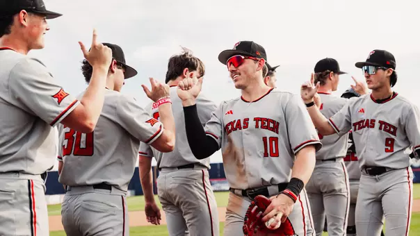 Logan Hughes (10) and the Red Raiders shake hands in celebration following the 12-10 win over Arizona Sunday afternoon