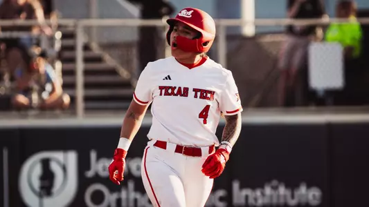 Lagi Quiroga celebrating with her teammates during a softball game