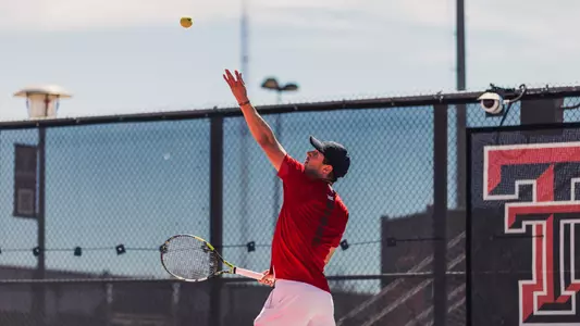 Sebastian Abboud tossing the ball up to serve. Texas Tech vs UTSA Men's Tennis on March 22, 2026. (Photo by Joseph Cabrera/ Texas Tech Athletics)