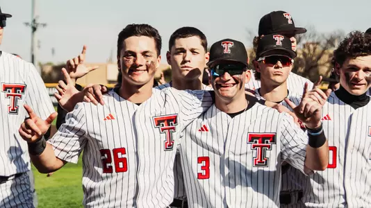 Infielders Matt Quintanar and Tracer Lopez pose after the Red Raiders 12-2 win over UNM Tuesday