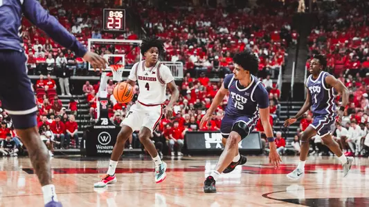 Christian Anderson looks for an opening with TCU defenders guarding him.