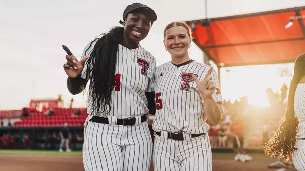 Kaitlyn Terry and NiJaree Canady doing the guns up symbol after beating another team