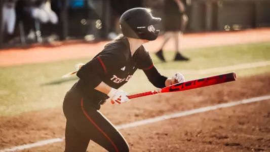 Hailey Toney leaving the batters box after recording a hit in a softball game