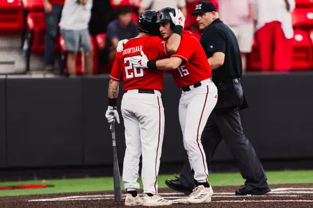 DH Caden Ferraro and C Matt Quintanar celebrate Ferraro's second inning solo home run